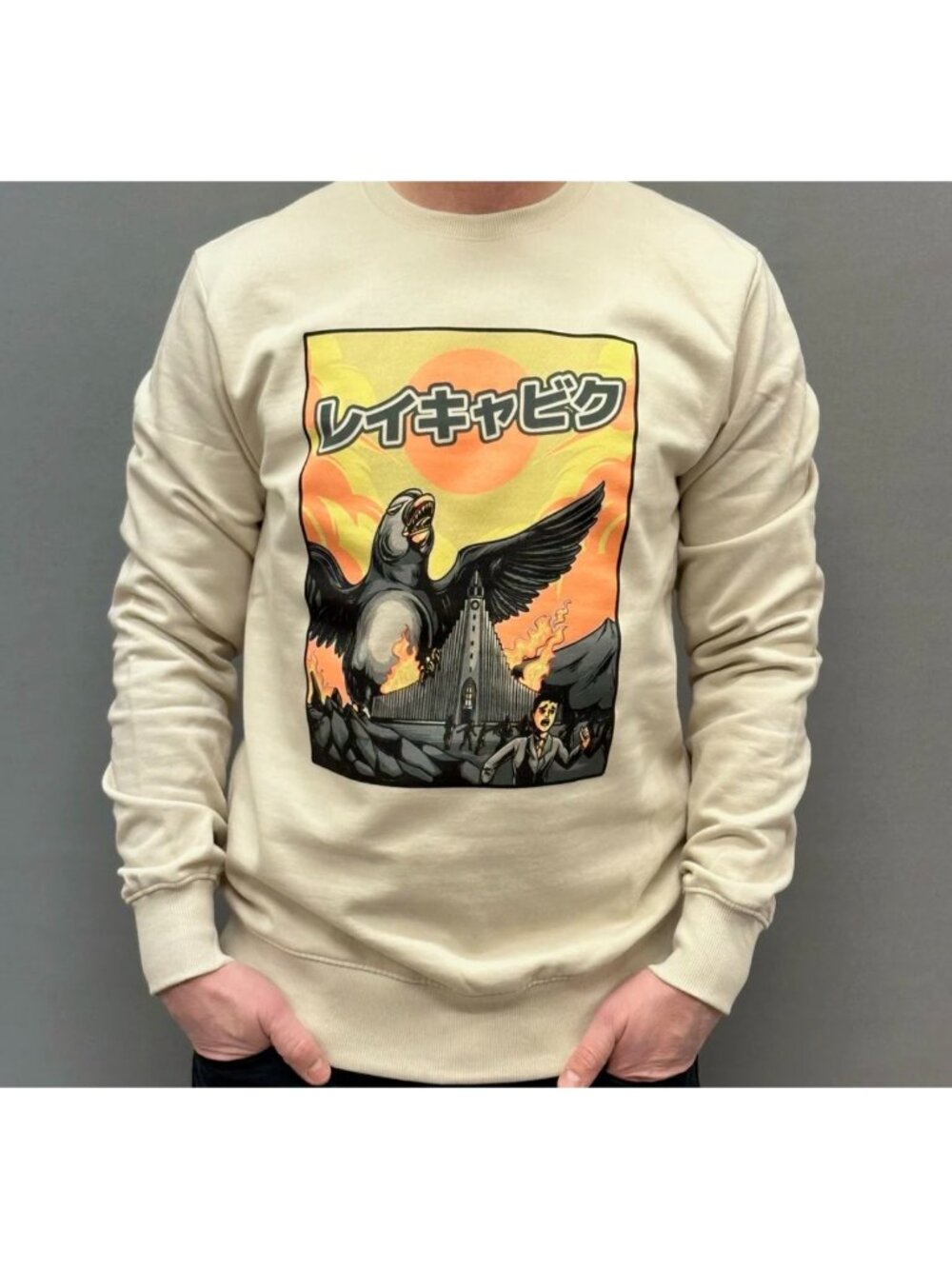 sweatshirt Puffzilla graphic depicting a giant puffin attacking Reykjavik beige